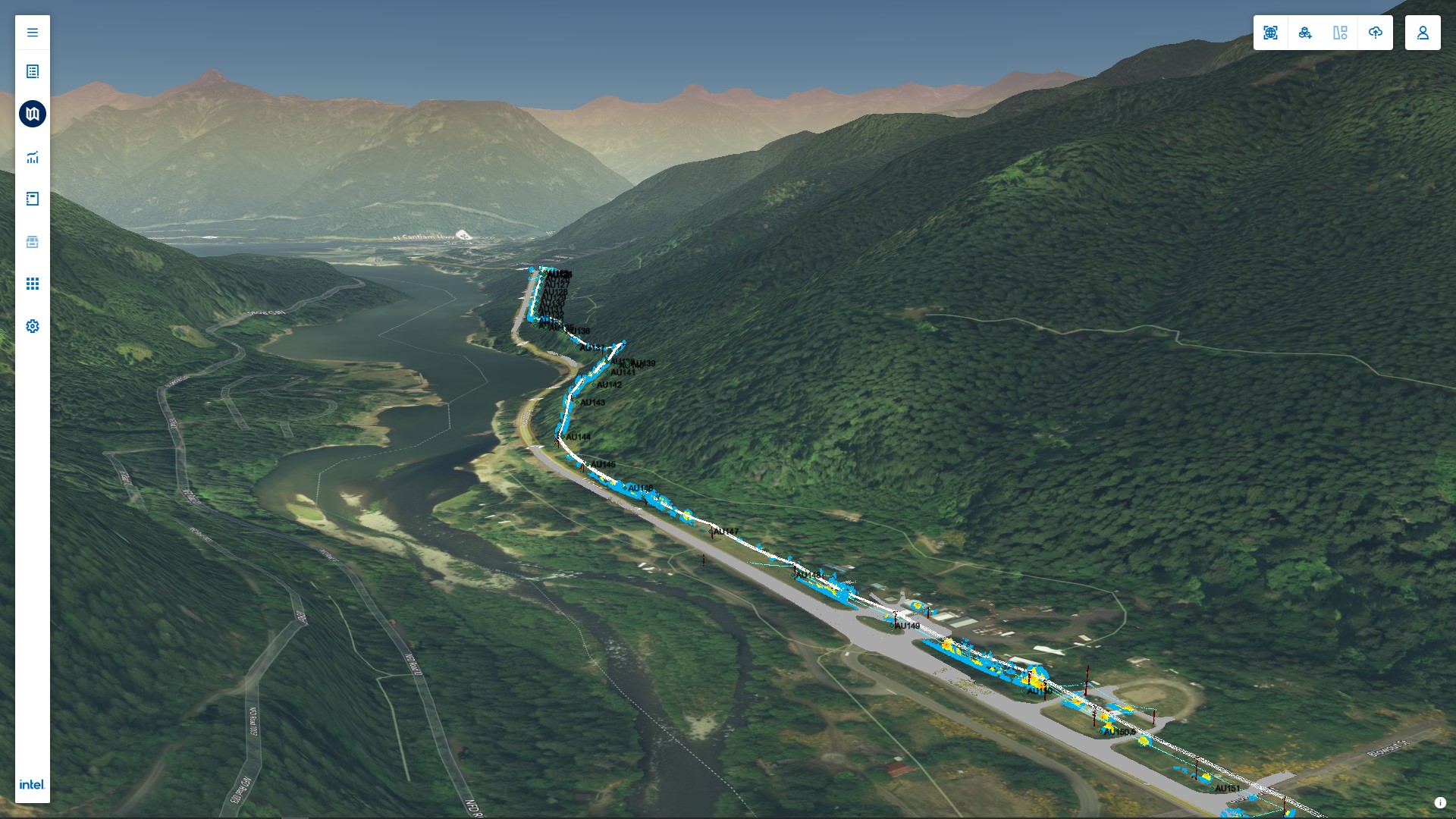 A 3D geospatial map visualization showing a network infrastructure or utility line running through a mountain valley by a river, with path details and analytic overlays displayed. The interface includes navigation tools on the left, and the terrain is detailed with forested mountains and water features.