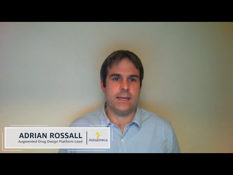 A person identified as Adrian Rossall, Augmented Drug Design Platform Lead at AstraZeneca, is speaking in front of a plain background. There is a name and title plaque displayed on screen.