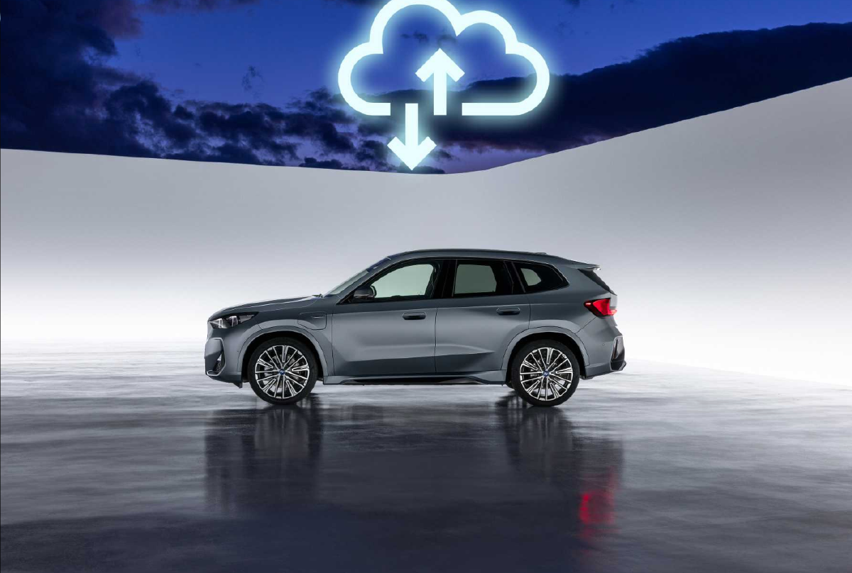 A modern SUV vehicle is displayed in a clean, futuristic setting with a large illuminated cloud connectivity symbol above it, representing technology integration and automotive cloud solutions.