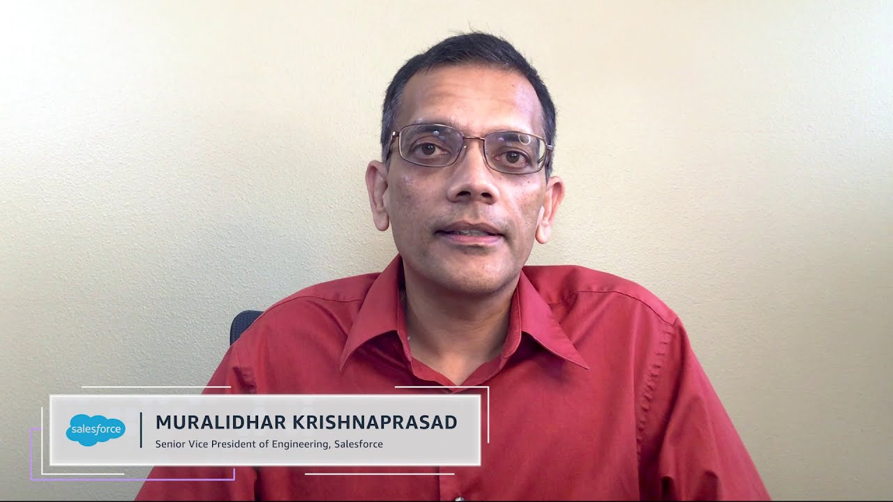 A person in a red shirt and glasses is seated in front of a plain wall. A lower third identifies them as the Senior Vice President of Engineering at Salesforce.
