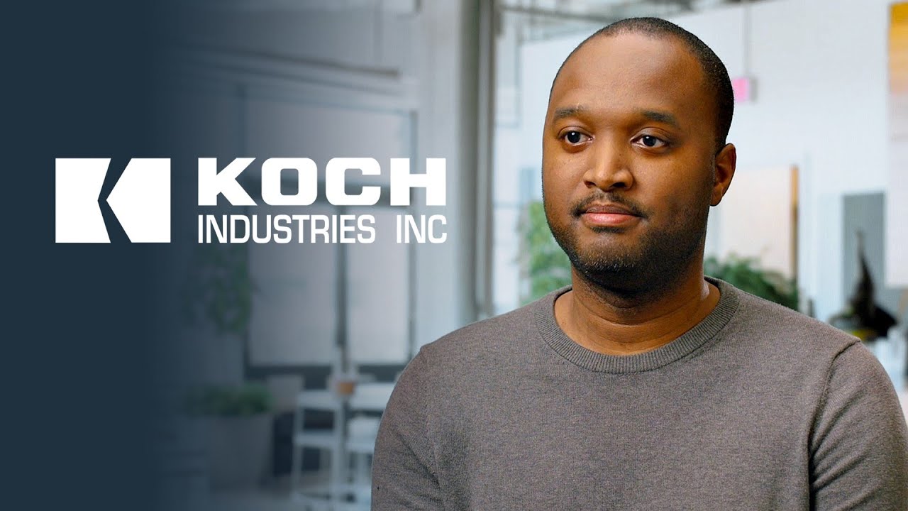 YouTube thumbnail image featuring a person in a gray sweater with the Koch Industries Inc logo on the left, set in a modern office environment.