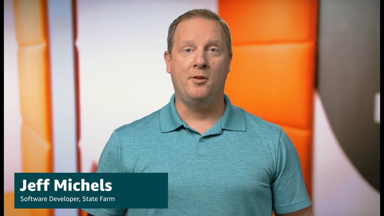 A person in a teal shirt standing in front of an orange and white geometric background. There is a caption in the image that reads 'Jeff Michels, Software Developer, State Farm.'