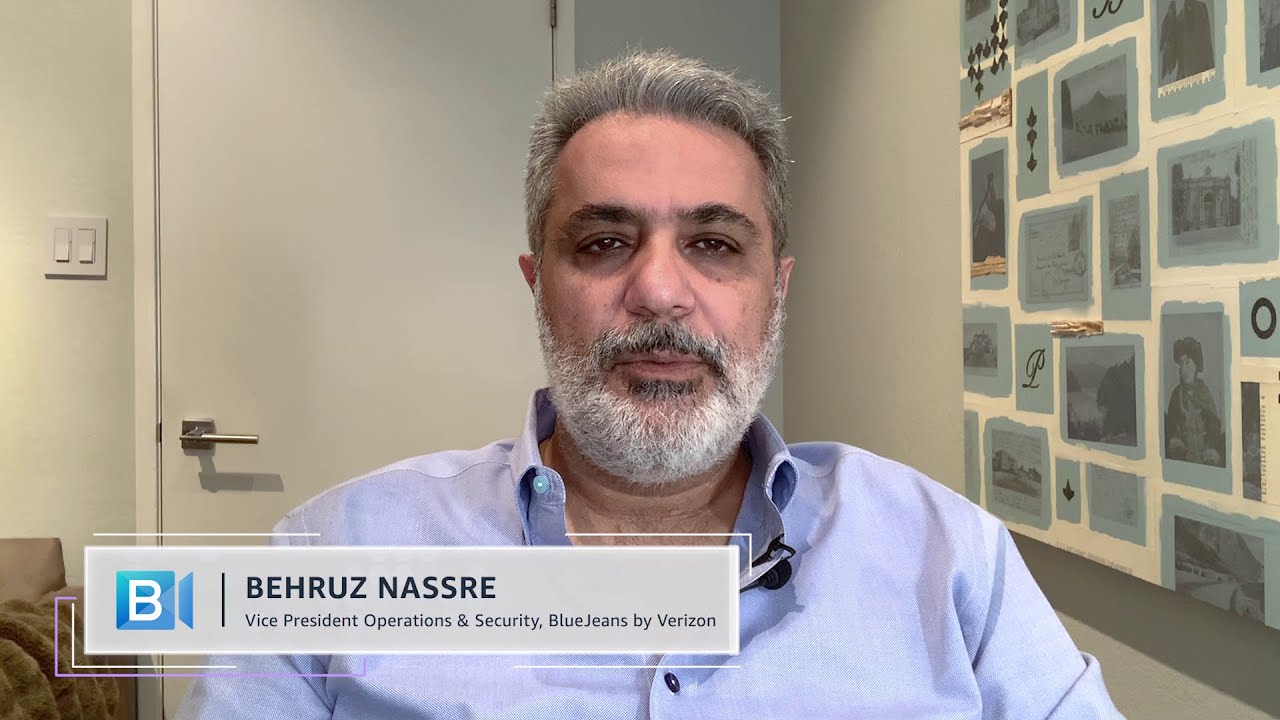 A person speaking in an interview setting with a title card showing 'Behruz Nassre, Vice President Operations & Security, BlueJeans by Verizon' visible on screen.
