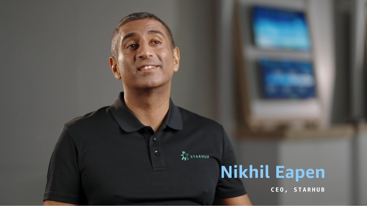 YouTube thumbnail featuring Nikhil Eapen, CEO of StarHub, during an interview, with a blurred office background.