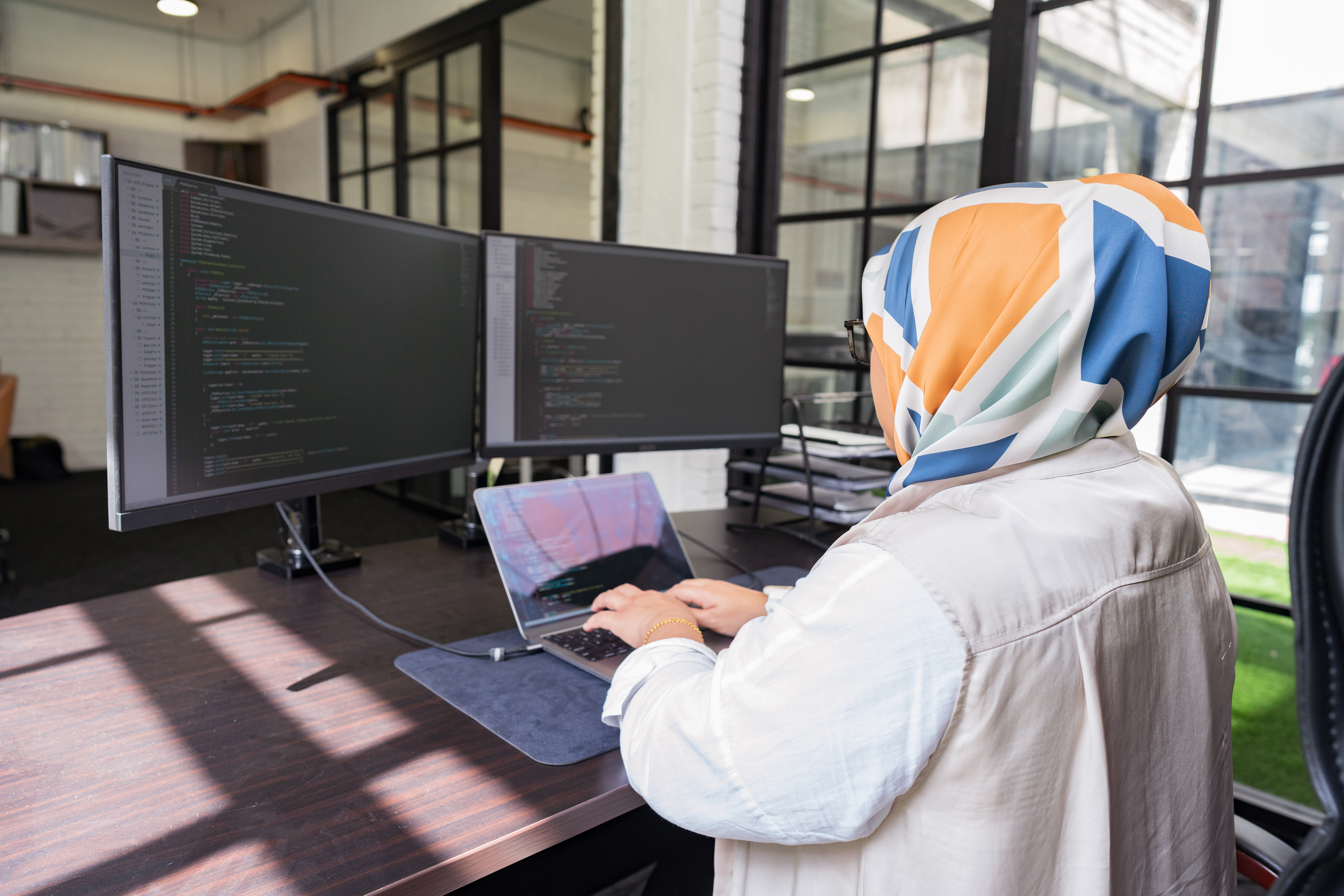 Colleagues working with device and collaborating at office