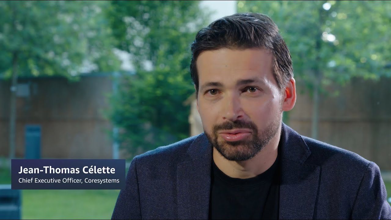 Jean-Thomas Célette, Chief Executive Officer of Coresystems, speaking during an interview, with trees and a building visible in the background.