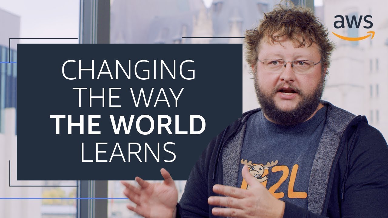 YouTube thumbnail image showing a person speaking, with the text 'Changing the Way the World Learns' and the AWS logo in the corner.