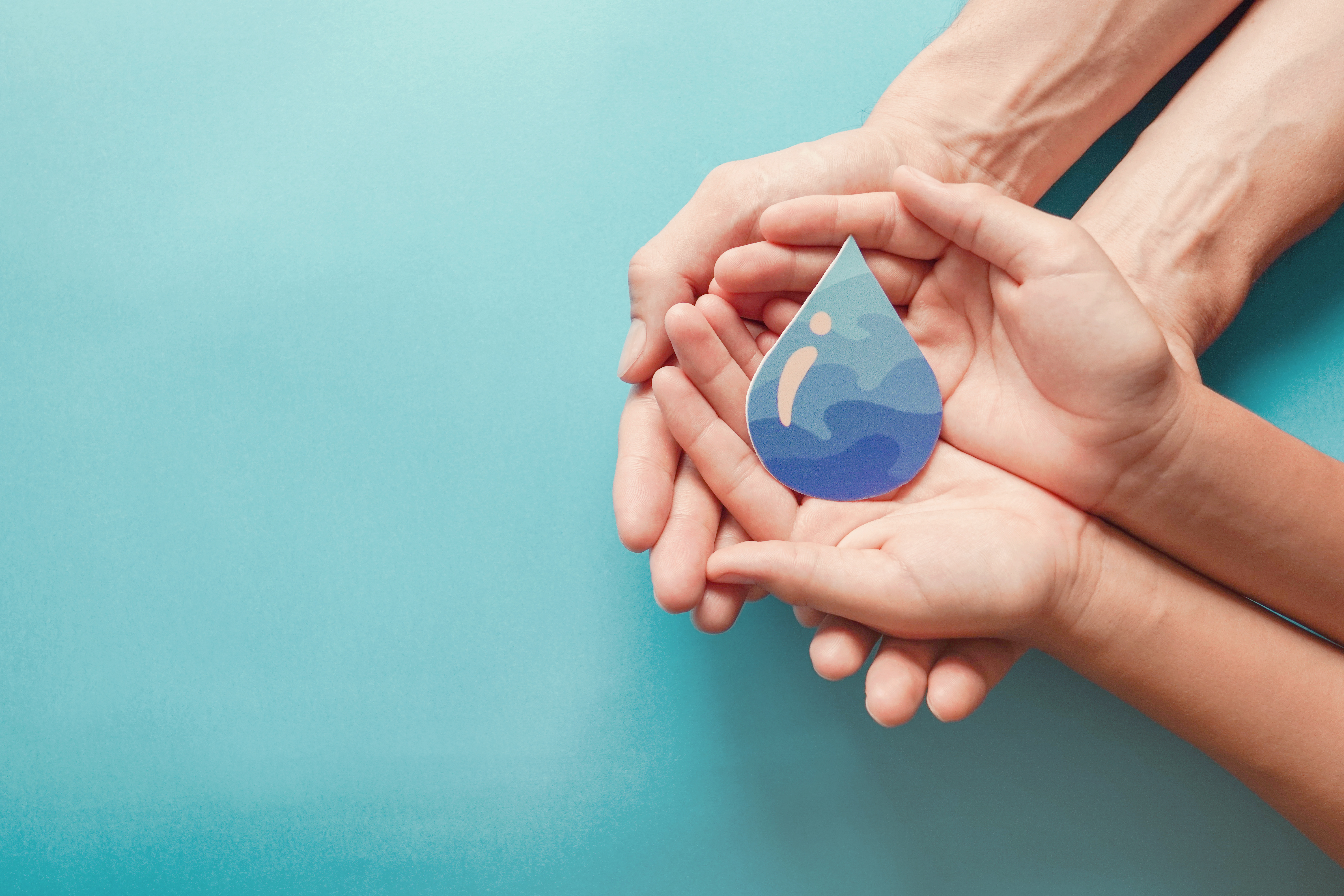 Adult and child hands holding paper cut water drop, World Water Day,  Clean water and sanitation, CSR, save water,  ecology concept  