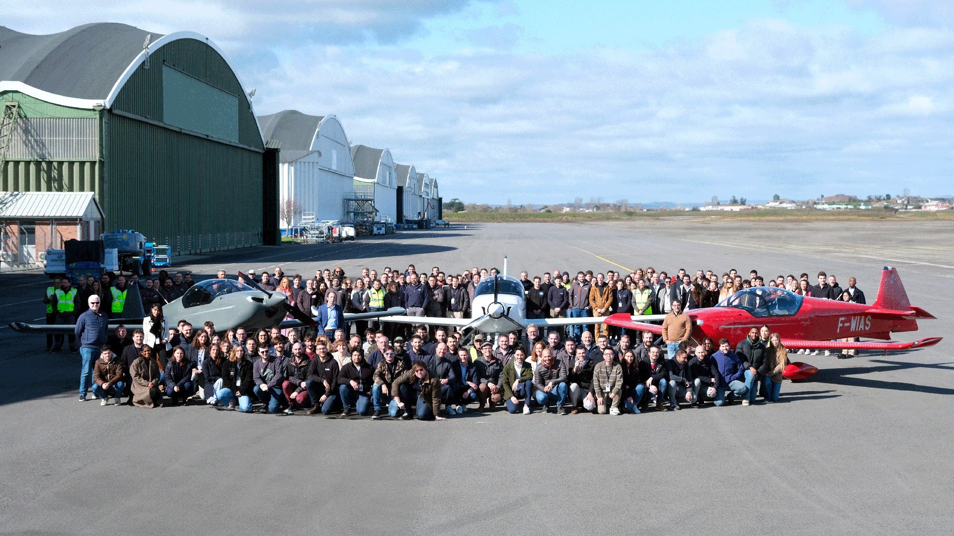 Aura Aero large group photo with aircraft at hangar