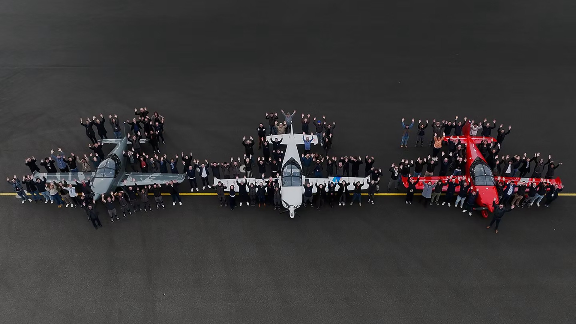 Aura Aero people posing with three airplanes