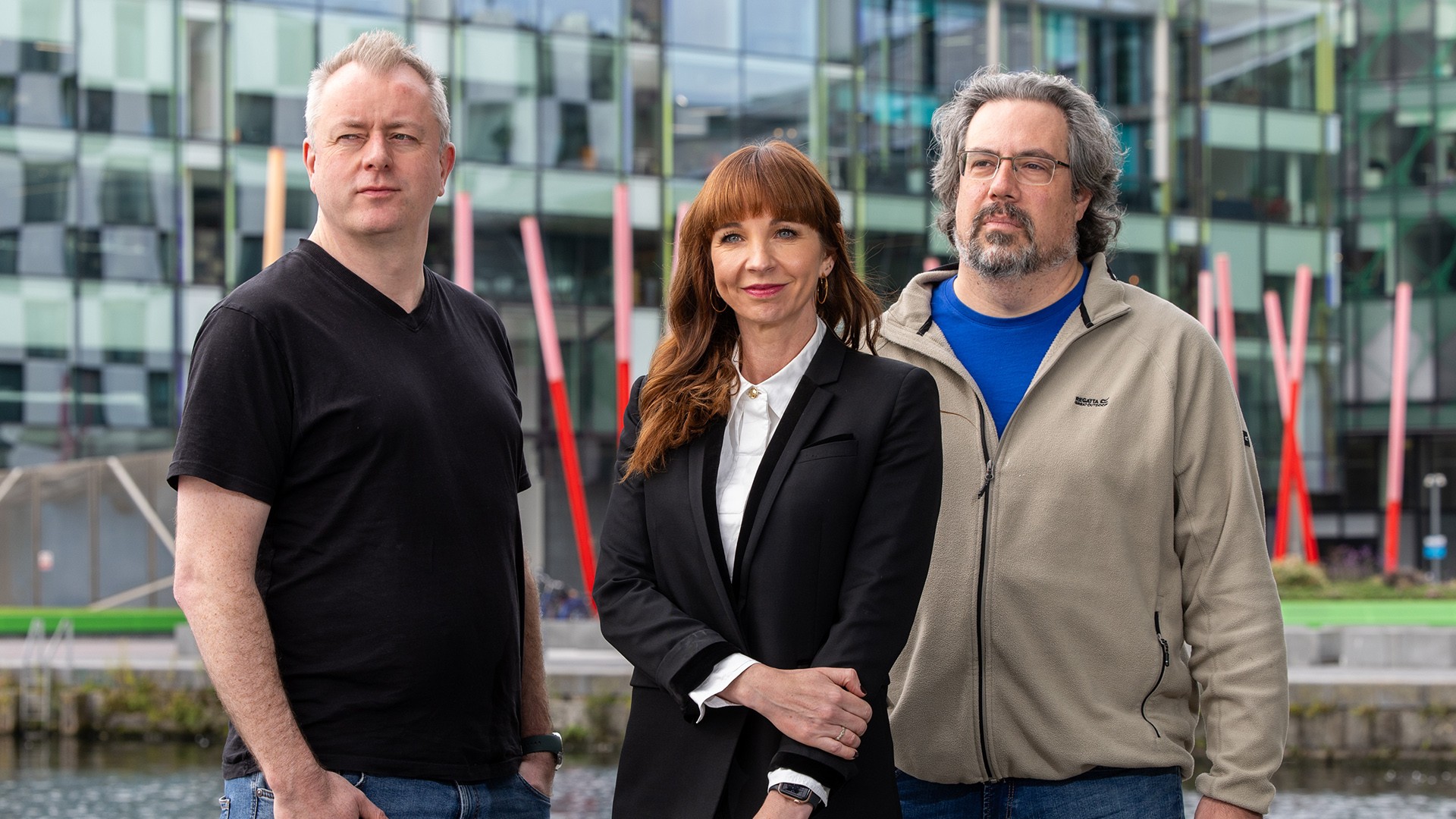 Jentic co-founders Sean Blanchfield (CEO), Dorothy Creaven (COO), and Michael Cordner (CTO) standing outside a modern building