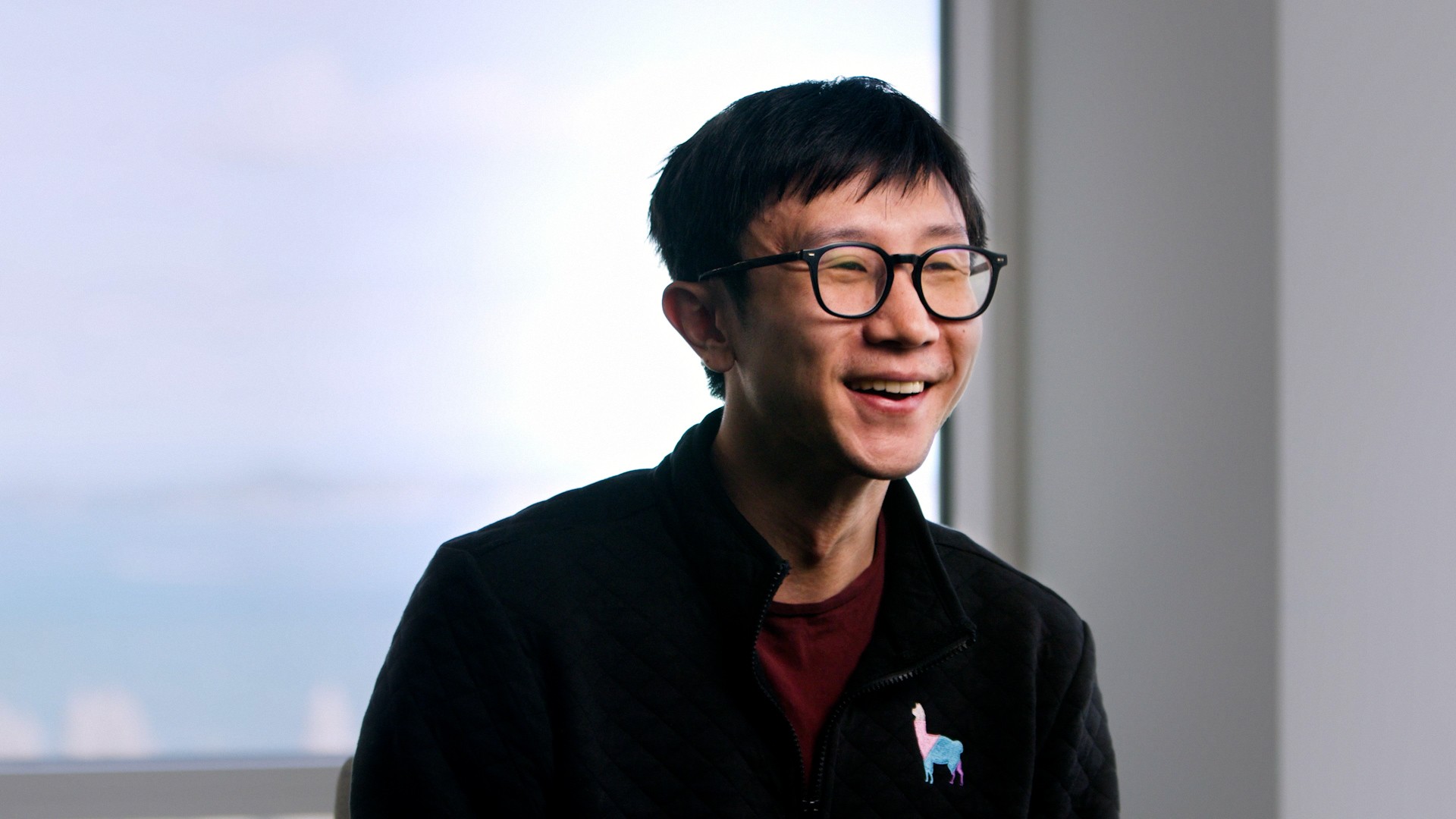 Smiling startup founder wearing glasses indoors, illustrating the An appetite for risk section.