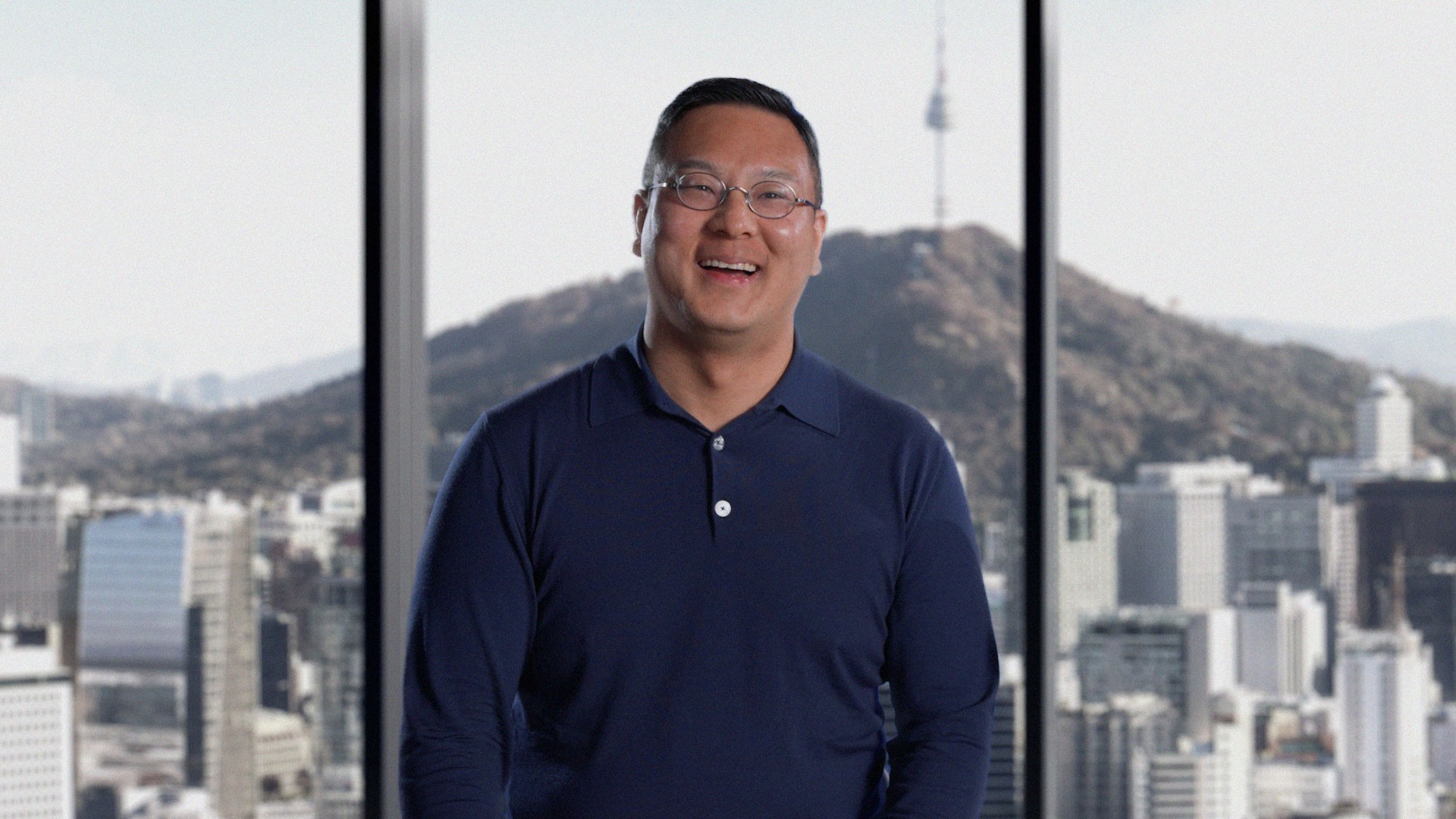 A Config founder smiling in front of a Seoul cityscape