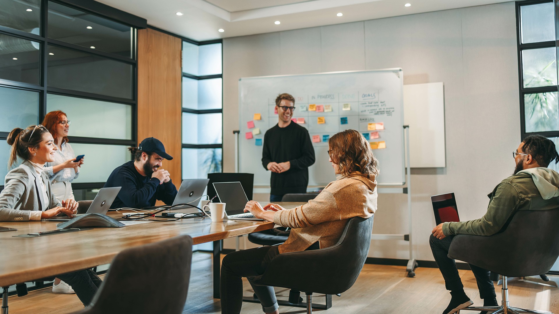 Team gathered around a table in a product strategy workshop meeting