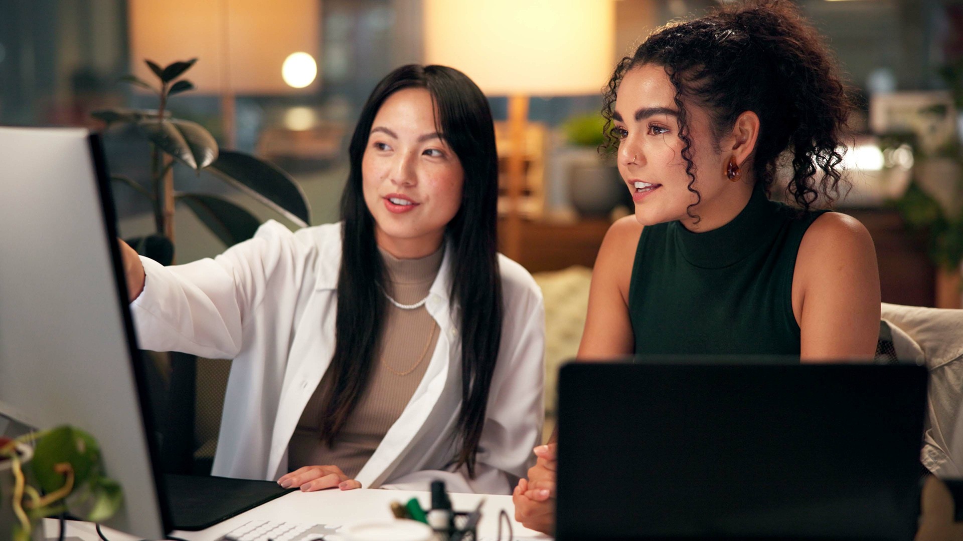 Two coworkers analyzing data at a workstation