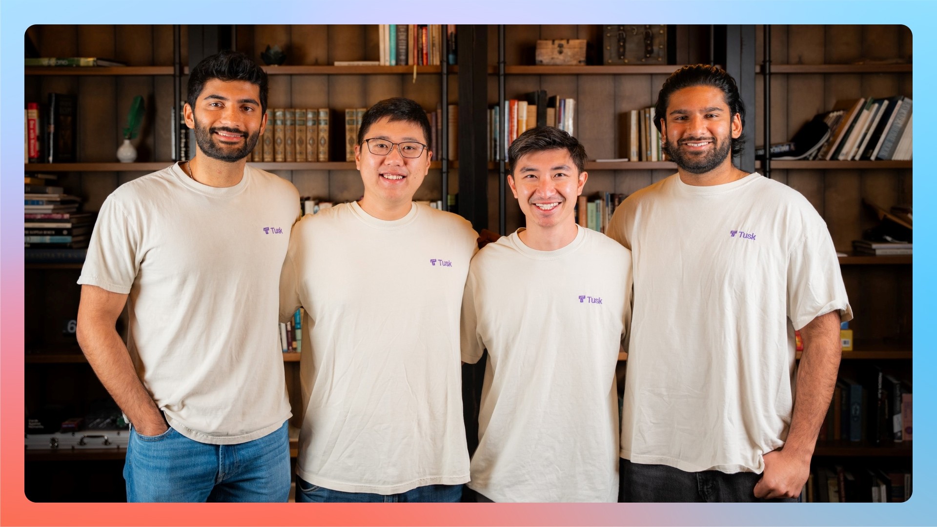 The four-person Tusk founding team standing together in an office in front of a bookshelf.