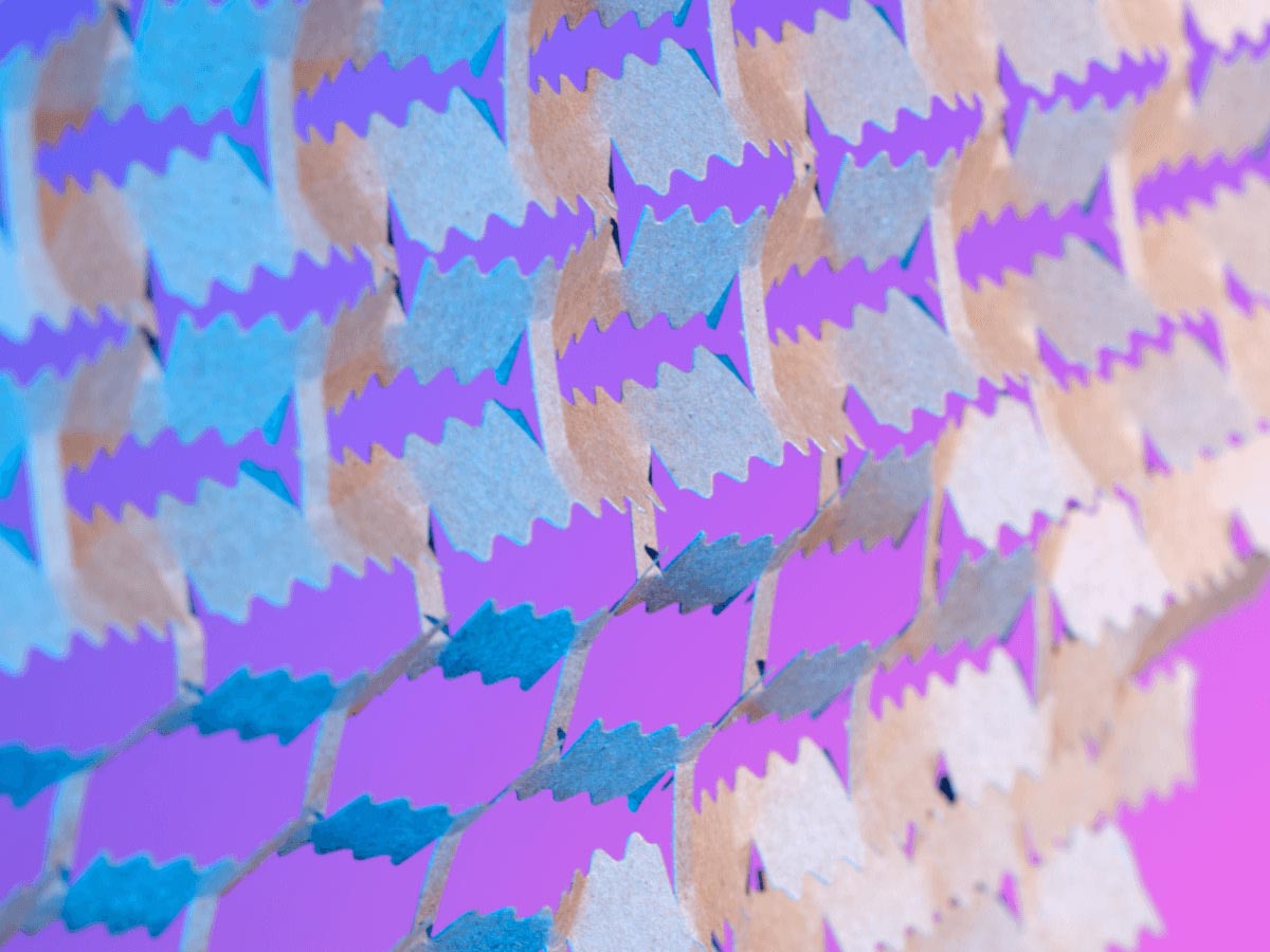 Close-up texture of layered purple, blue, and neutral paper shapes