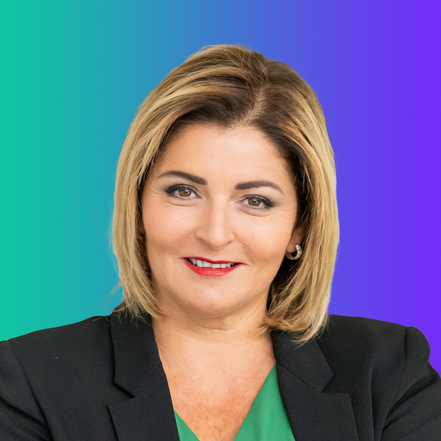 Professional headshot portrait of a woman in a business suit, taken for the AWS Executive Leaders event in Paris, shown against a blue and green gradient background.