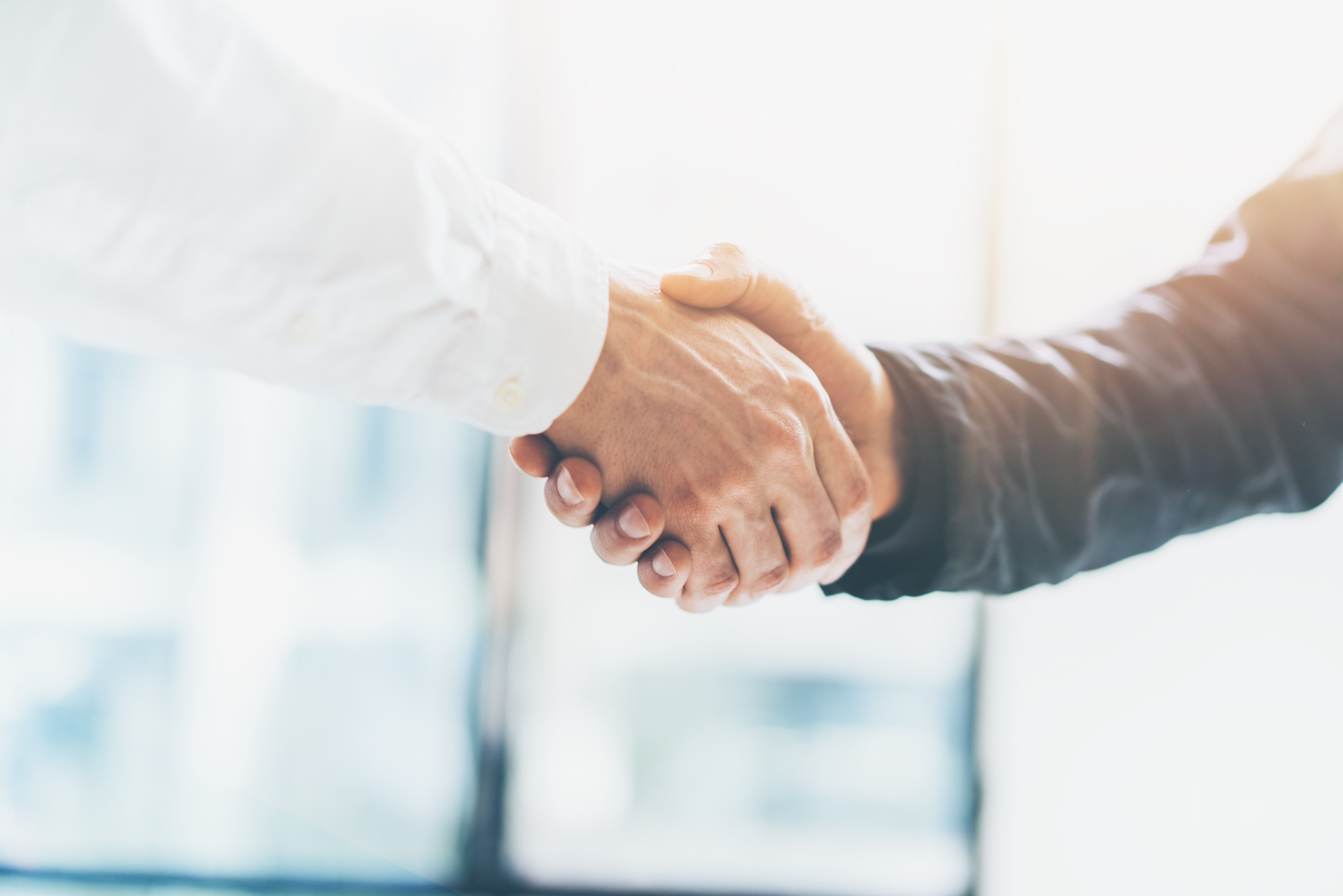 Business partnership meeting. Picture businessmans handshake. Successful businessmen handshaking after good deal. Horizontal, blurred background; Shutterstock ID 414162808; purchase_order: PDP pages; job: Wickr; Use Case: (internal materials or creative mockup): Webpage - PDPs for Wickr