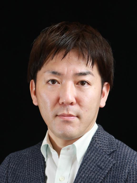 Professional portrait of a man in a suit jacket on a black background