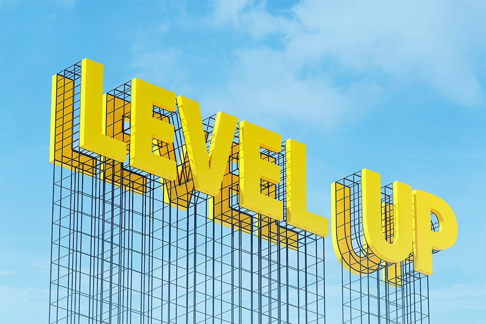 Yellow 3D letters spelling 'LEVEL UP' mounted on a structural frame against a clear blue sky background.