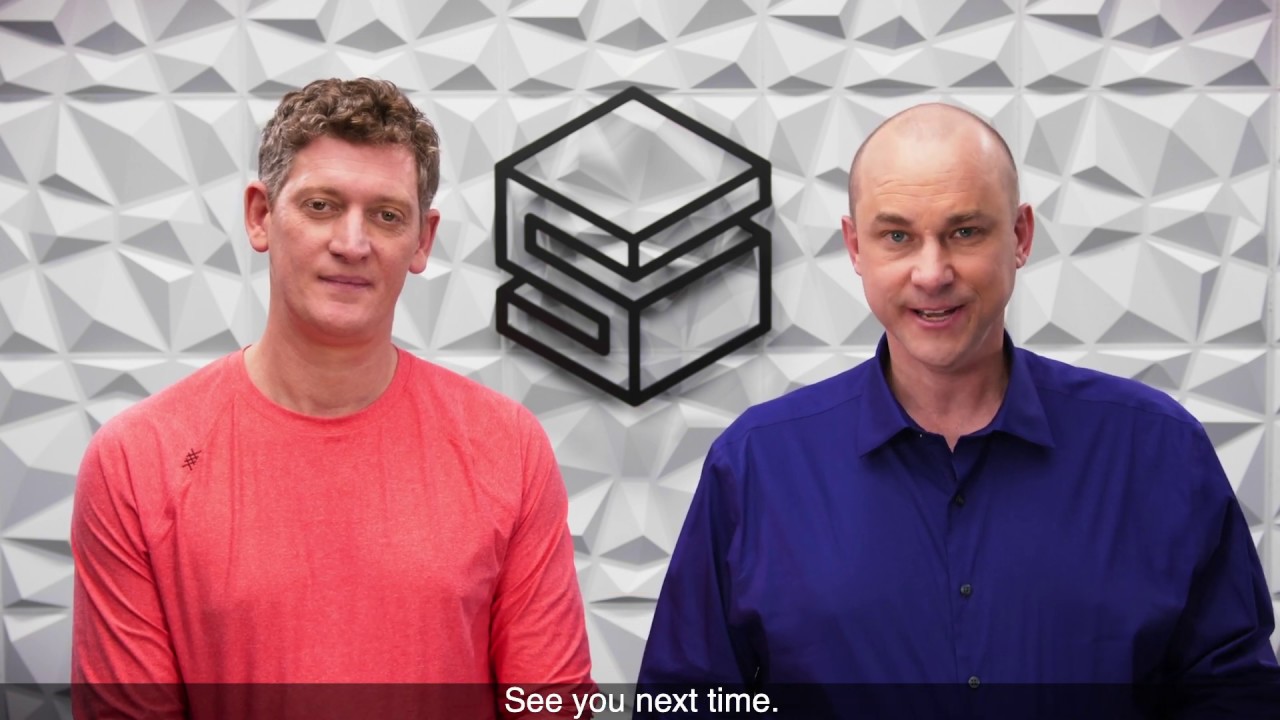 Two men standing in front of a geometric wall background with a studio logo, featuring the subtitle 'See you next time.'