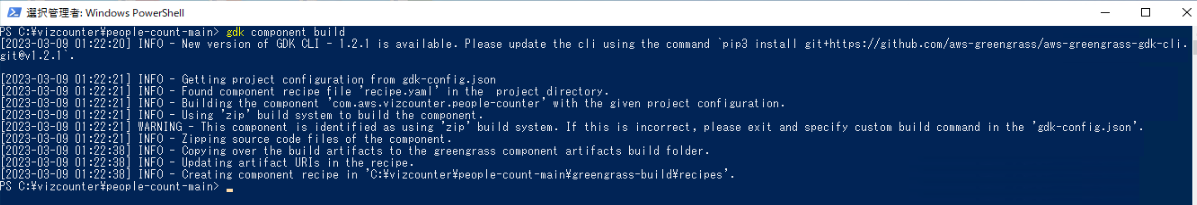 Screenshot of a Windows PowerShell window showing the output for 'gdk component build' for the AWS Greengrass GDK, displaying messages about project configuration, build warnings, file zipping, and artifact updates.