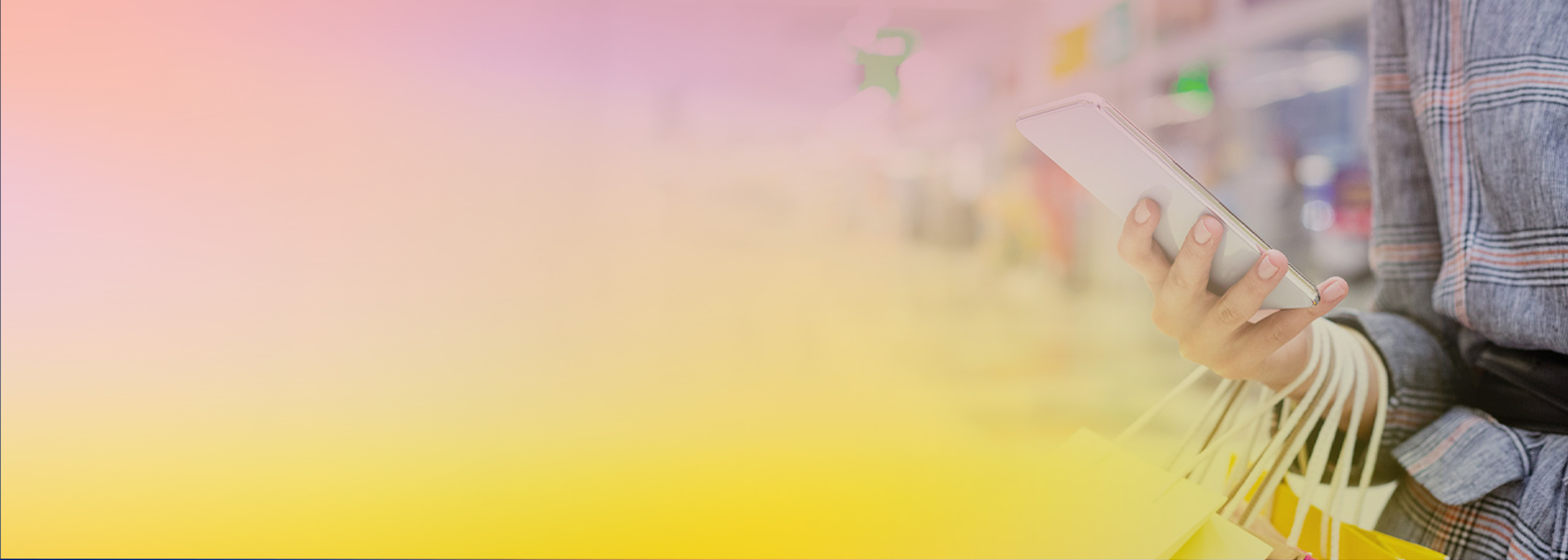 A person holding a smartphone and several shopping bags, set against a blurred retail environment with a soft gradient overlay of pink and yellow hues.