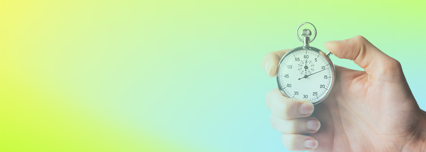 A hand holding a classic stopwatch against a yellow and blue gradient background.