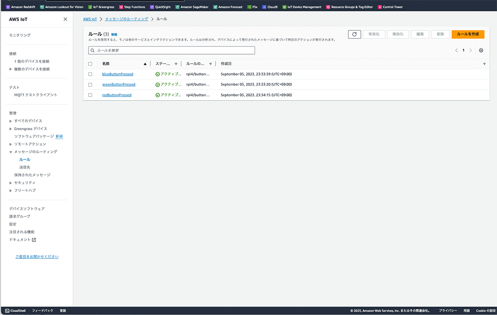 AWS IoTコンソールのメッセージルーティングのルール管理画面を表示したスクリーンショット。複数のルール(blueButtonPressed, greenButtonPressed, redButtonPressed)がリストされている。日本語インターフェースで示されている。