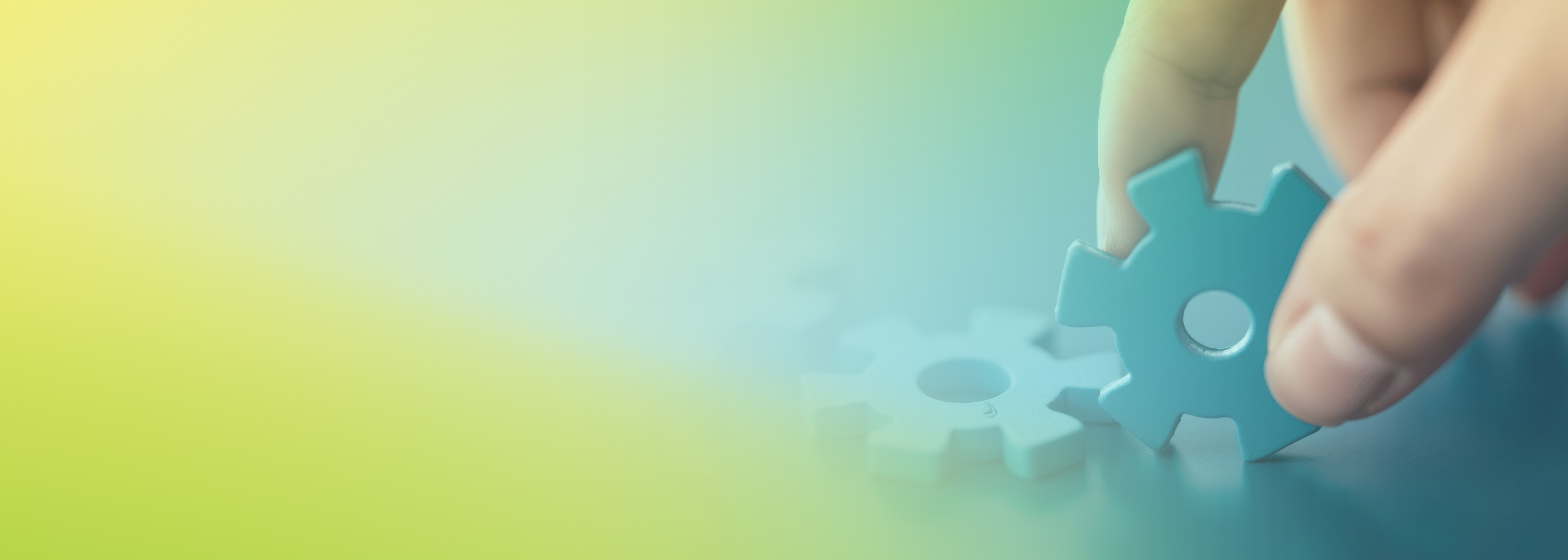 A close-up of a hand placing a blue gear among other gears, symbolizing building, integration, and automated unit testing with AWS CDK. The background has a blue and green gradient, emphasizing focus on technology and development.