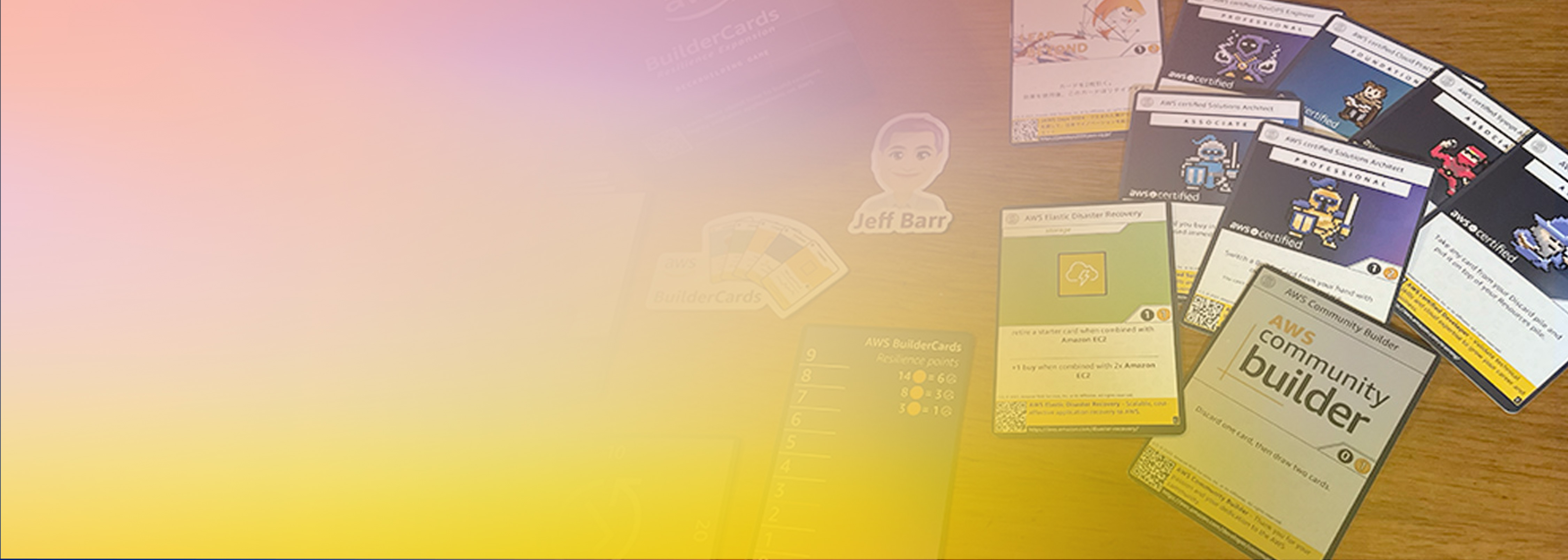 A spread of AWS BuilderCards in Japanese, including community builder and certification cards, arranged on a wooden surface with a gradient overlay to the left. Used for developer engagement and community activities in Japan.