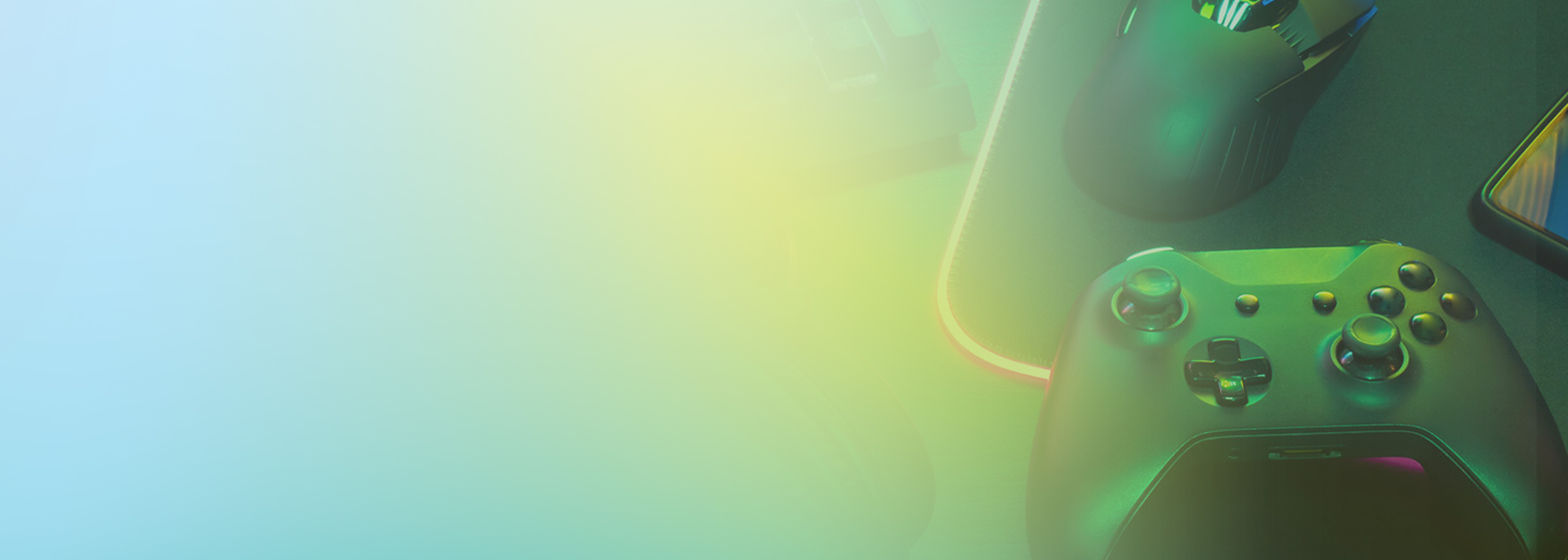 A top-down view of a gaming controller, mouse, mouse pad, and smartphone on a desk with a green and yellow gradient overlay, representing game development or backend services.