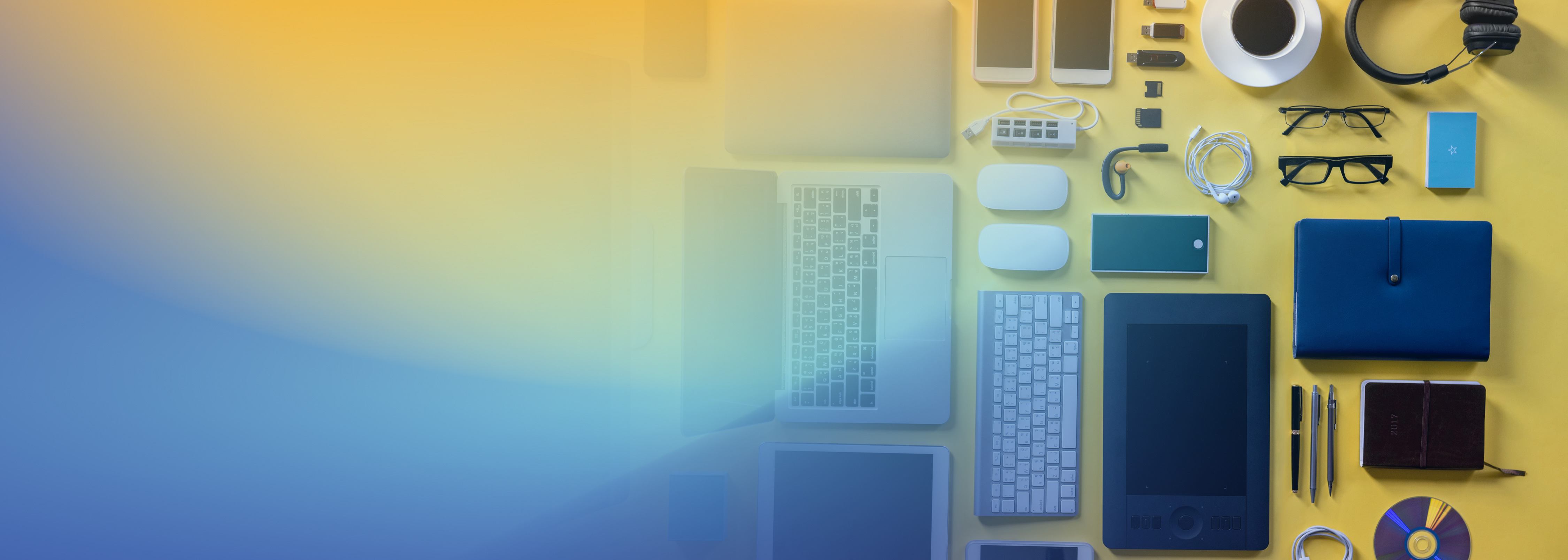 A flat lay of various tech gadgets and accessories including a laptop, mobile phones, mouse, keyboard, headphones, coffee cup, glasses, and other items arranged on a yellow background with a blue and yellow gradient overlay.