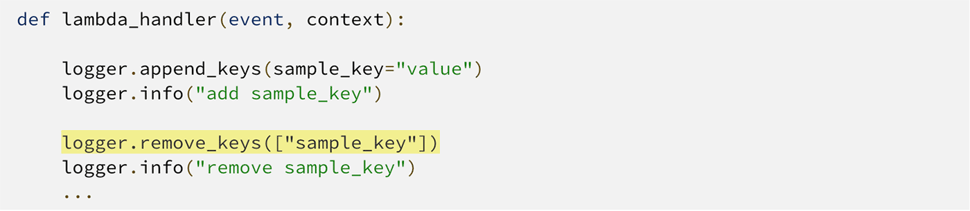 Screenshot of Python code demonstrating the use of logger in AWS Lambda Powertools to append and remove log keys. The code shows adding a 'sample_key' to the logger and then removing it, with logging statements for both actions.