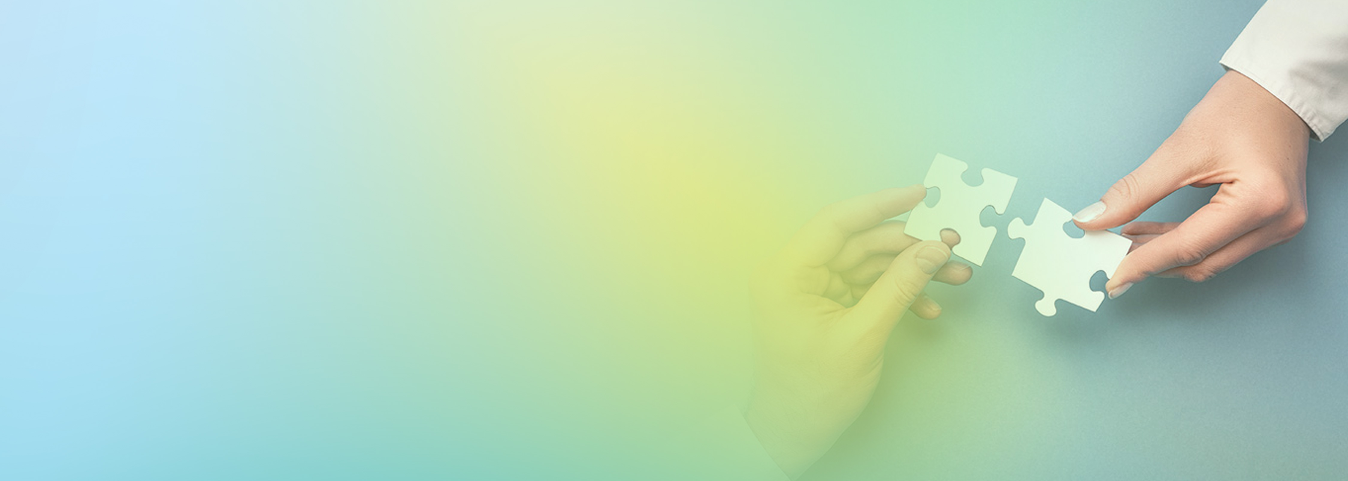 Two hands connecting puzzle pieces on a blue background, symbolizing learning and integration, with a soft gradient overlay.