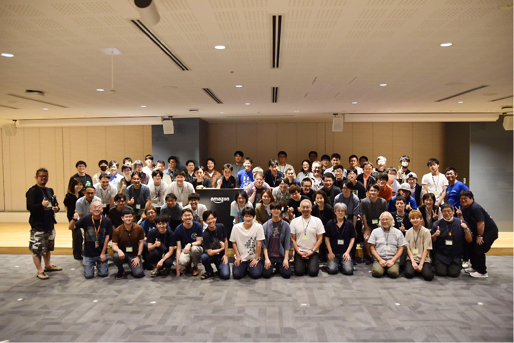 A large group of people posing together for a group photo at the AWS JAWS DAYS 2023 event, taken indoors in a conference setting.