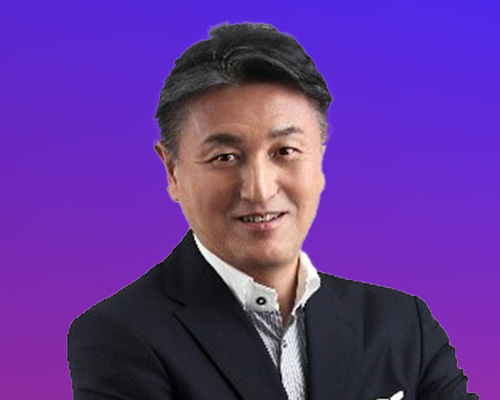 A business professional wearing a dark suit and white shirt, smiling in front of a blue and purple gradient background.