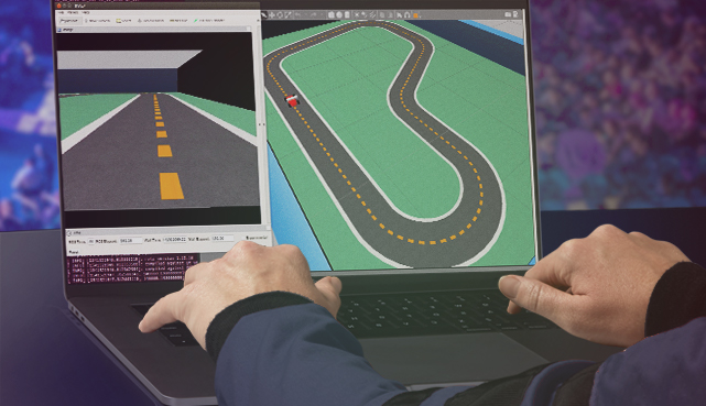 A person uses a laptop running the AWS DeepRacer simulator with the Silverstone track visible on the screen.