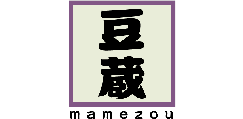 A square logo featuring the Japanese Kanji characters 豆蔵 (Mamezou) in bold black font, centered on a light background with a purple border.