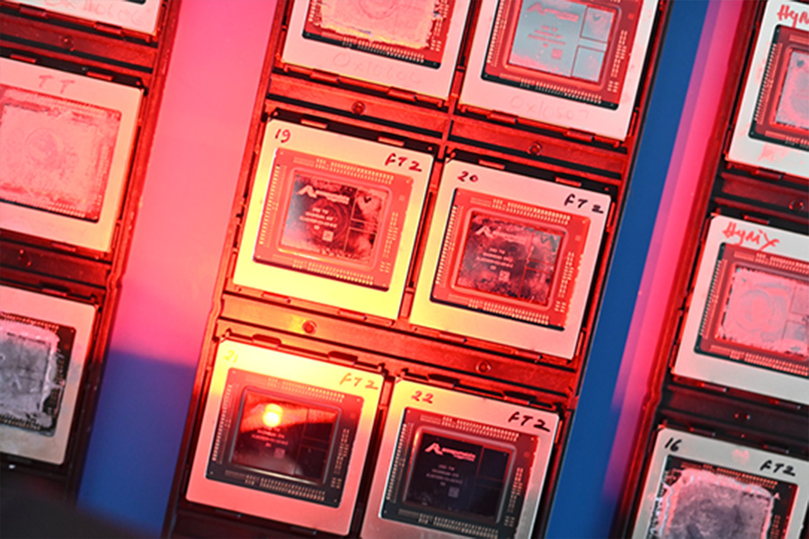 A close-up view of several microchips on display with red and blue lighting, featured at the AWS Summit 2025 Expo in Japan.