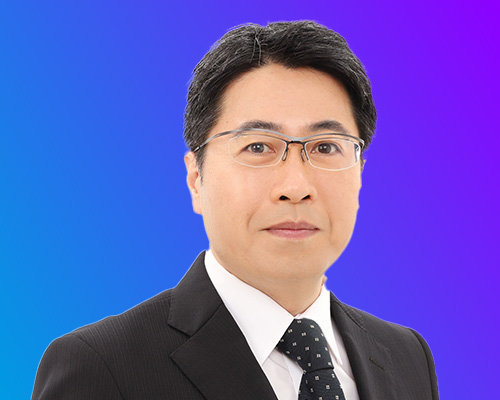 A portrait of a professional man in a dark suit, white shirt, and patterned tie, wearing glasses, set against a blue and purple gradient background. (AWS Summit Japan)