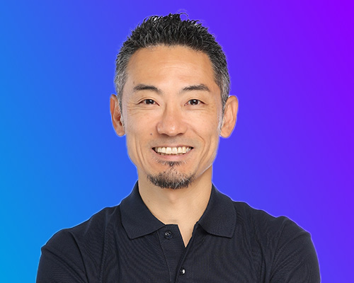 Portrait of a smiling man in a dark shirt on a blue-to-purple gradient background