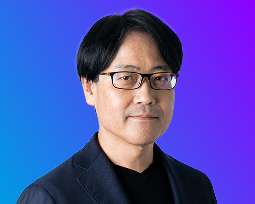 Portrait of a man in glasses and a dark jacket on a blue and purple gradient background