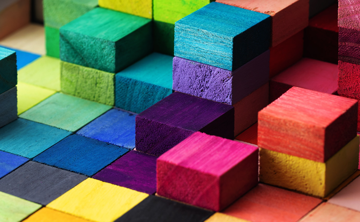 A close-up view of colorful wooden blocks arranged in a stepped, geometric pattern, representing creativity and building concepts. Suitable for illustrating artificial intelligence and machine learning themes.