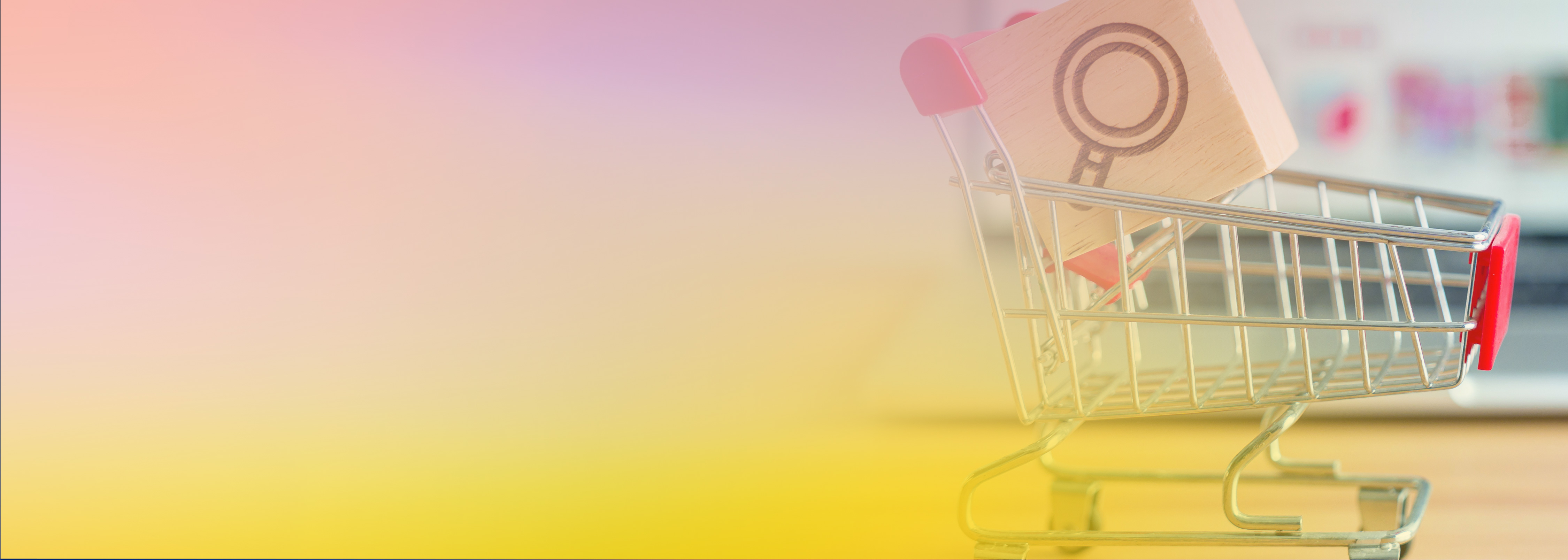 A small shopping cart containing a wooden block with a magnifying glass search icon, symbolizing search improvements with AI in e-commerce.