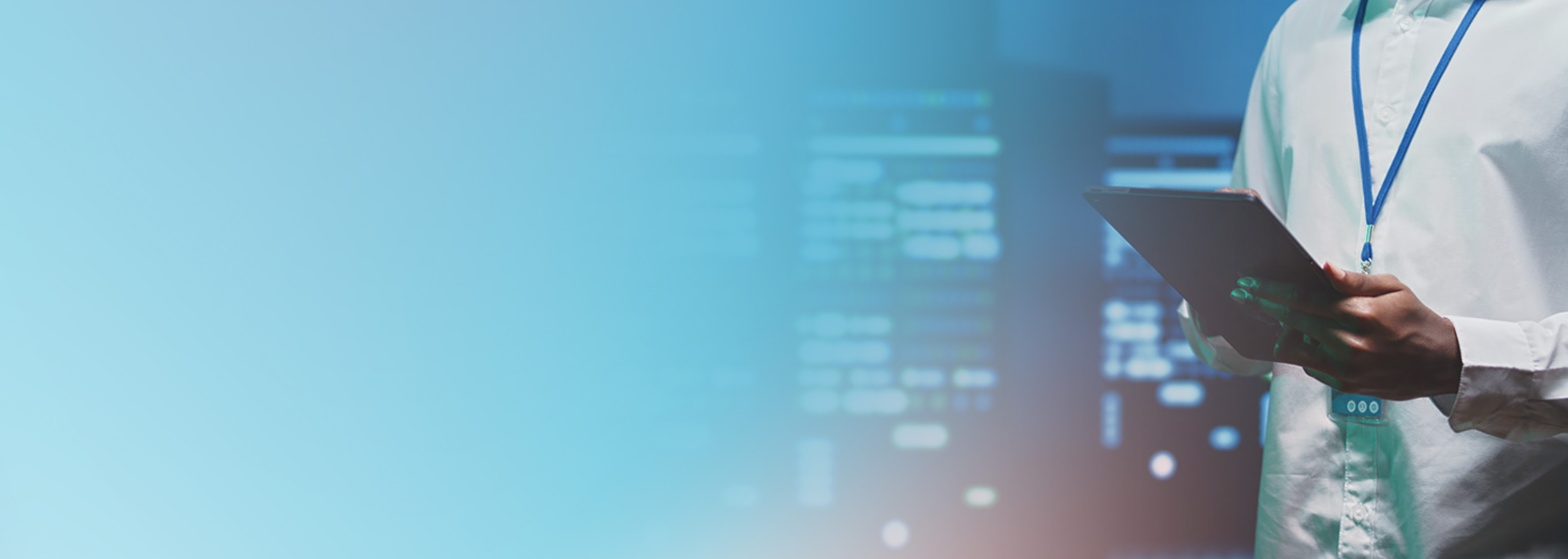 A person holding a tablet stands in front of server racks, representing automated infrastructure as code (IaC) deployment and management in a data center or cloud environment.