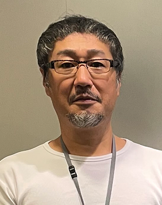 A portrait photograph of a man wearing glasses and a white shirt, featured in the Lifenet Insurance AWS case study.