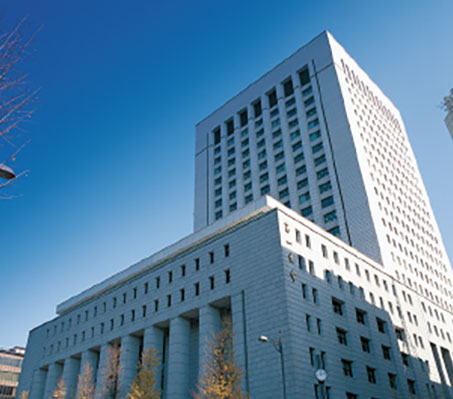 The exterior view of the Dai-ichi Life headquarters building in Tokyo, featuring modern architecture with a clear blue sky in the background.