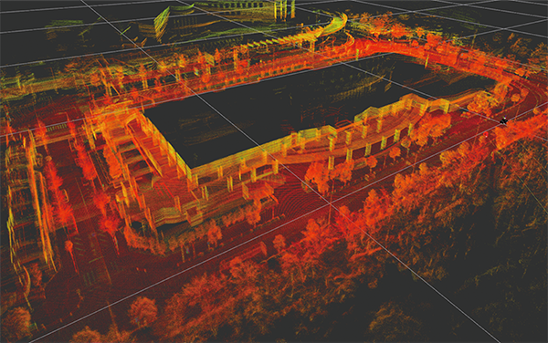 Colorized LiDAR point cloud visualization showing an urban environment, used in an AWS case study for Nagoya Railway. The image displays detailed 3D mapping with structures, roads, and vegetation in various colors highlighting data intensity, demonstrating advanced digital modeling and geospatial analysis applications.
